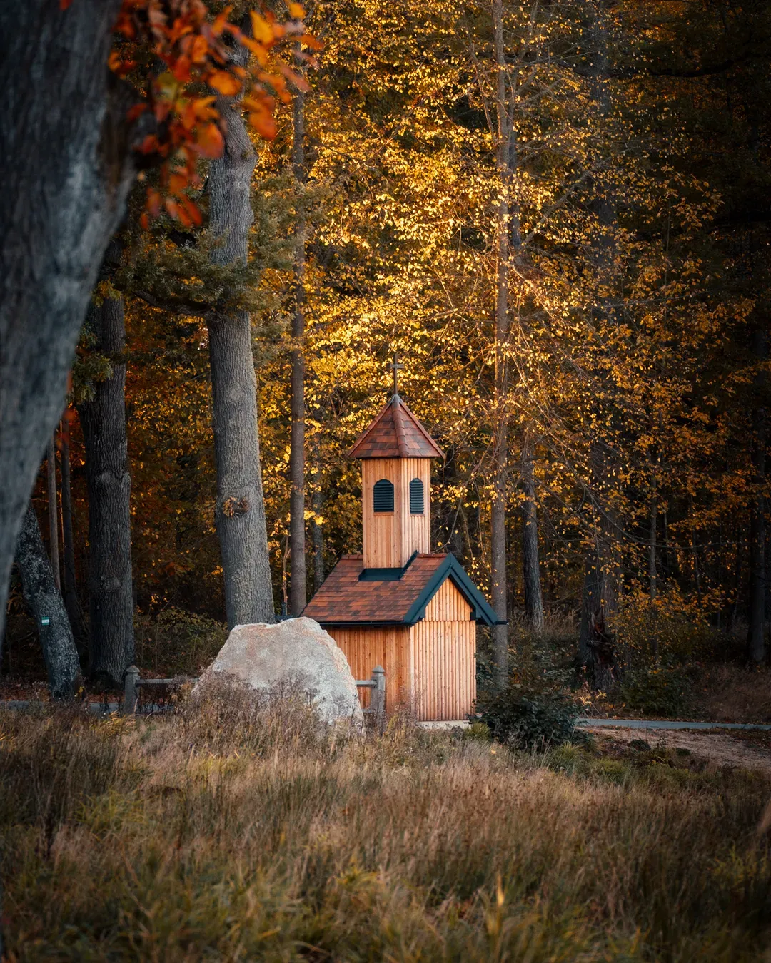 Kleine Holzkapelle im herbstlichen Wald